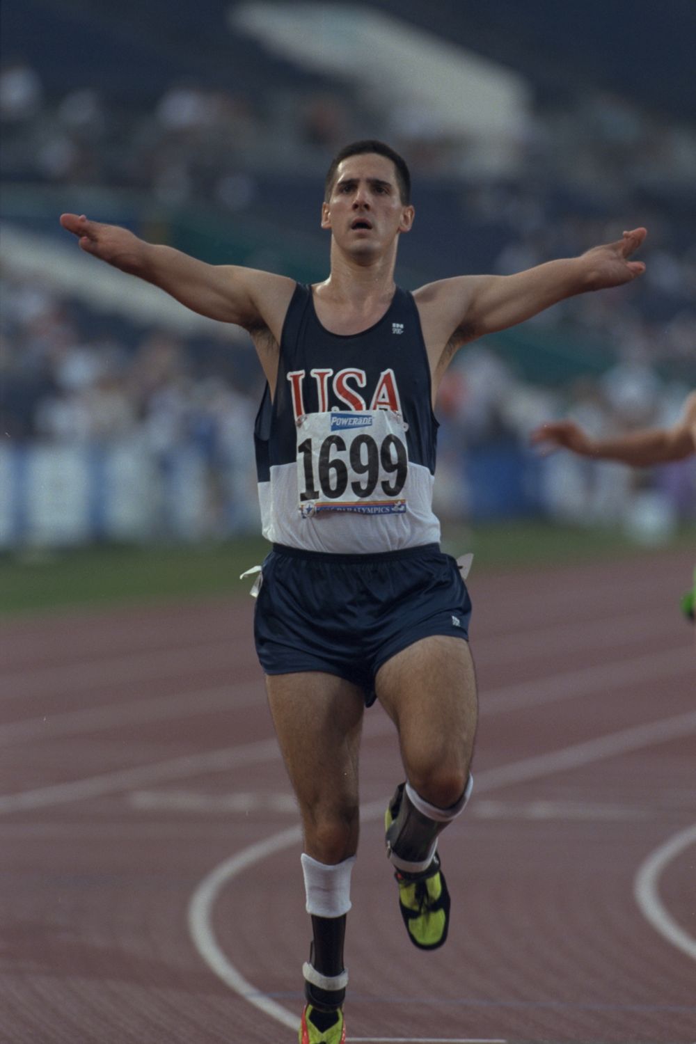 Tony Volpentest crossing the line with both arms outstretched