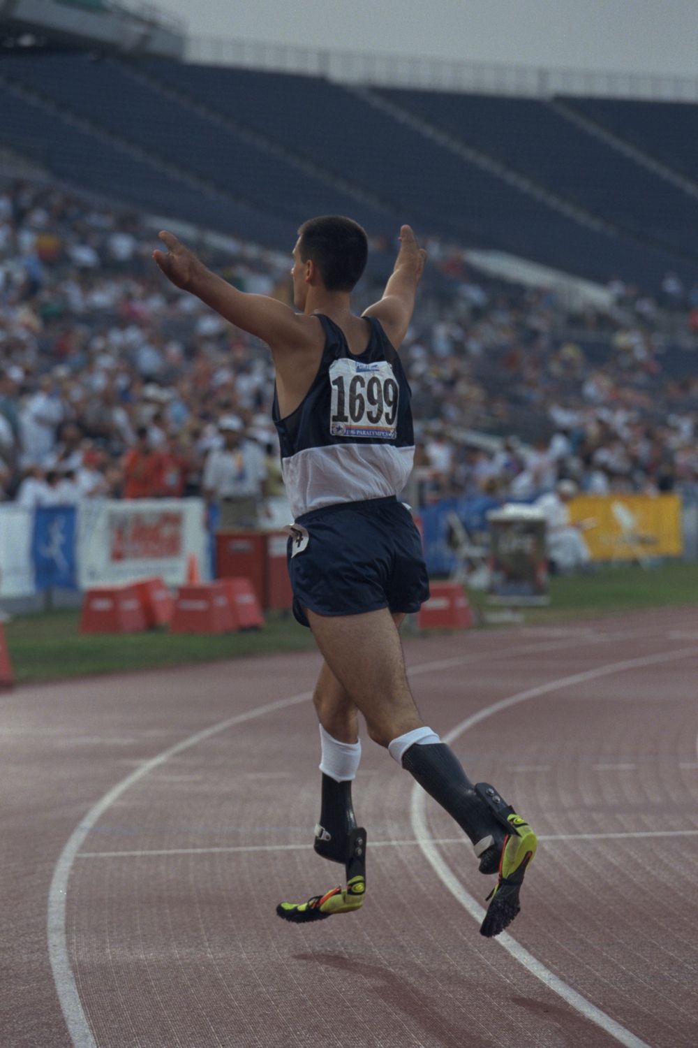 Tony Volpentest from behind on the bend after the finish, arms raised to the crowd
