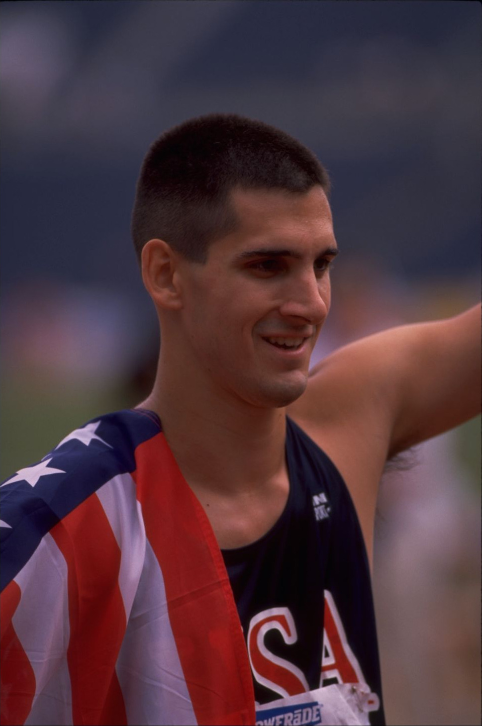Tony Volpentest in profile with a US flag over his shoulder