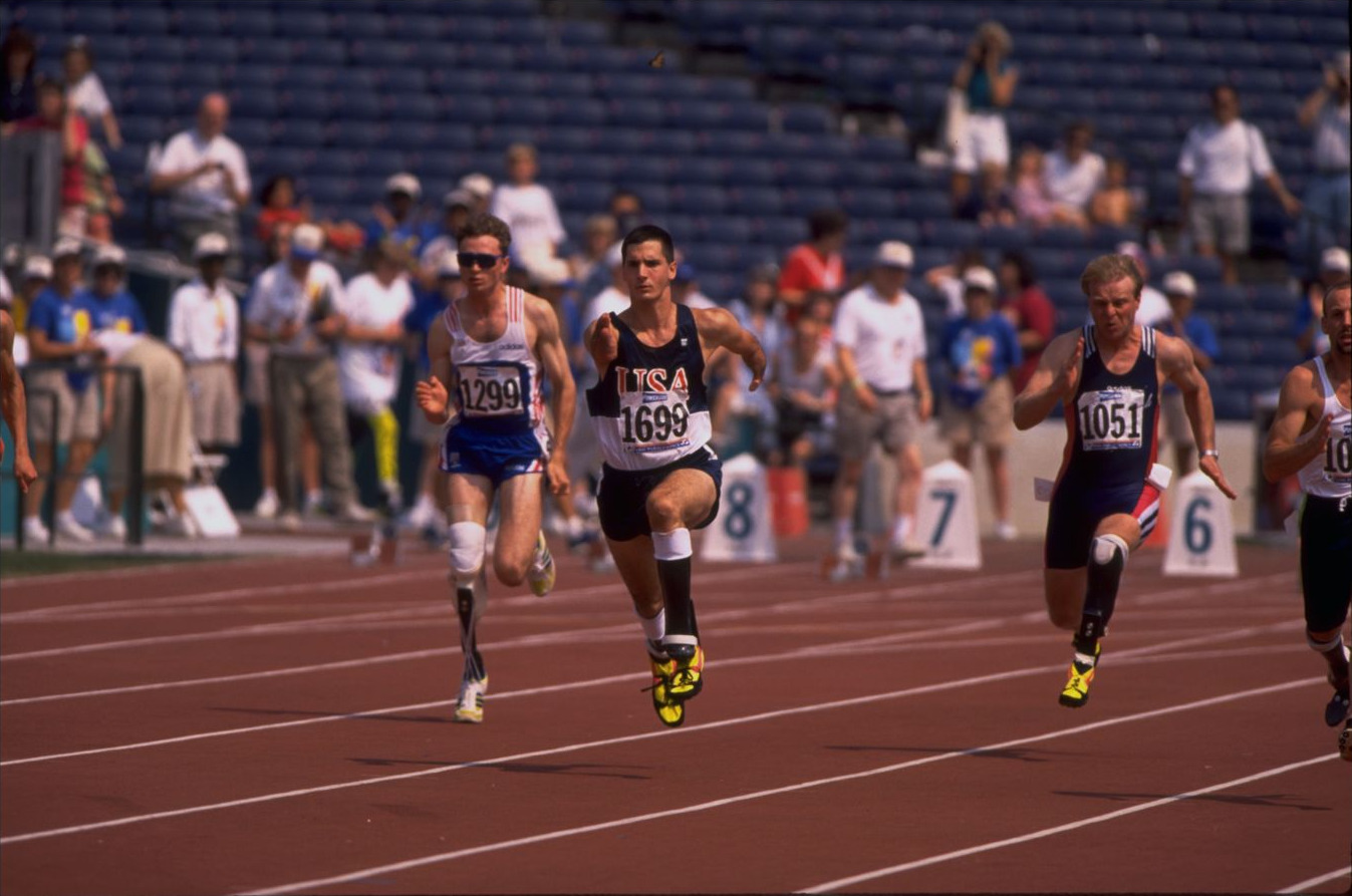 Tony Volpentest at full stride in lane, three runners alongside him