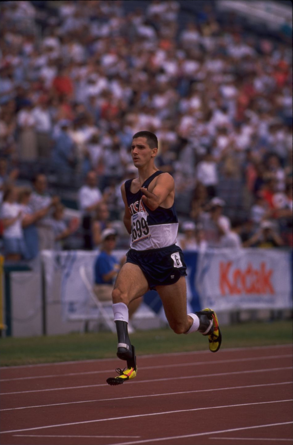 Tony Volpentest sprinting past a packed grandstand