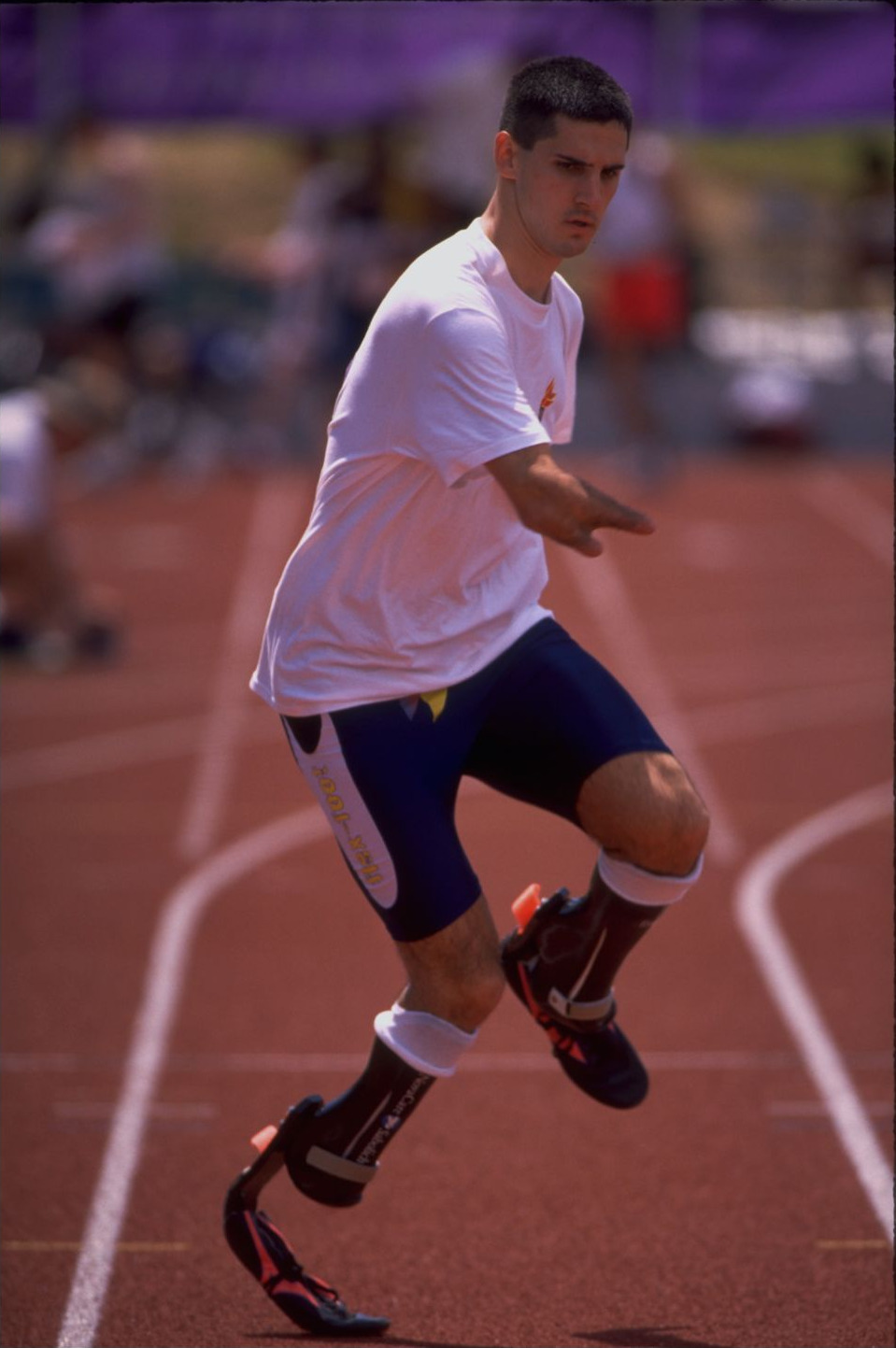 Tony Volpentest in a training top running a drill on the track